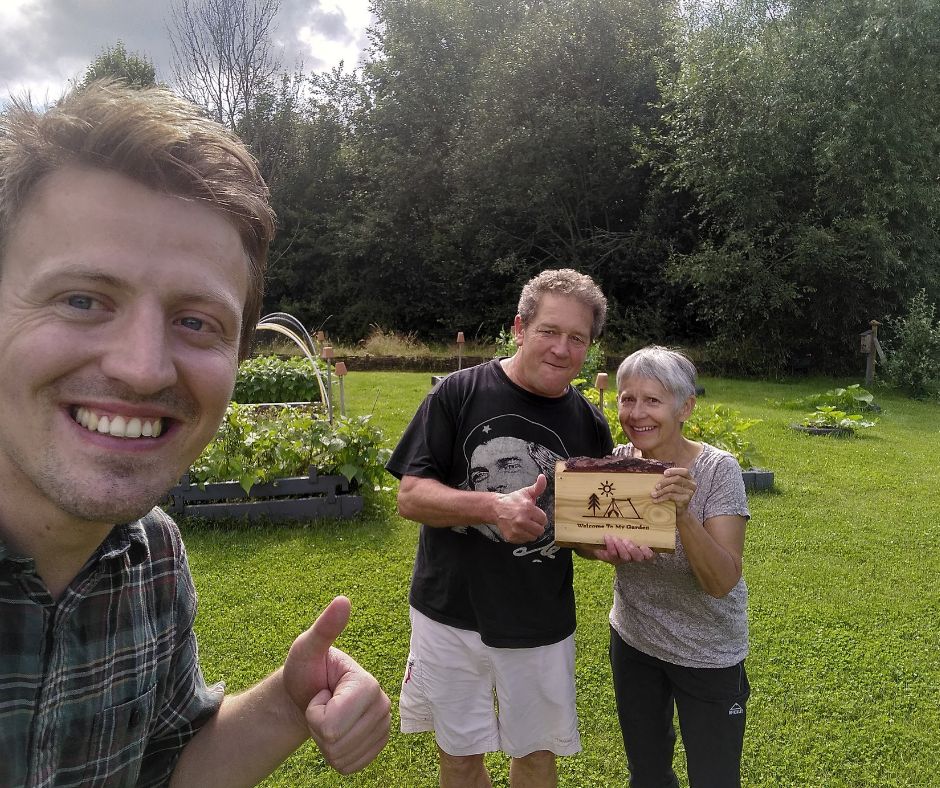 Two hosts holding a WTMG sign.